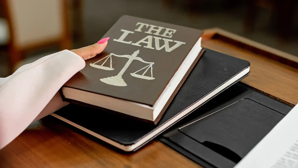 A book titled 'THE LAW' with a scales of justice symbol on the cover